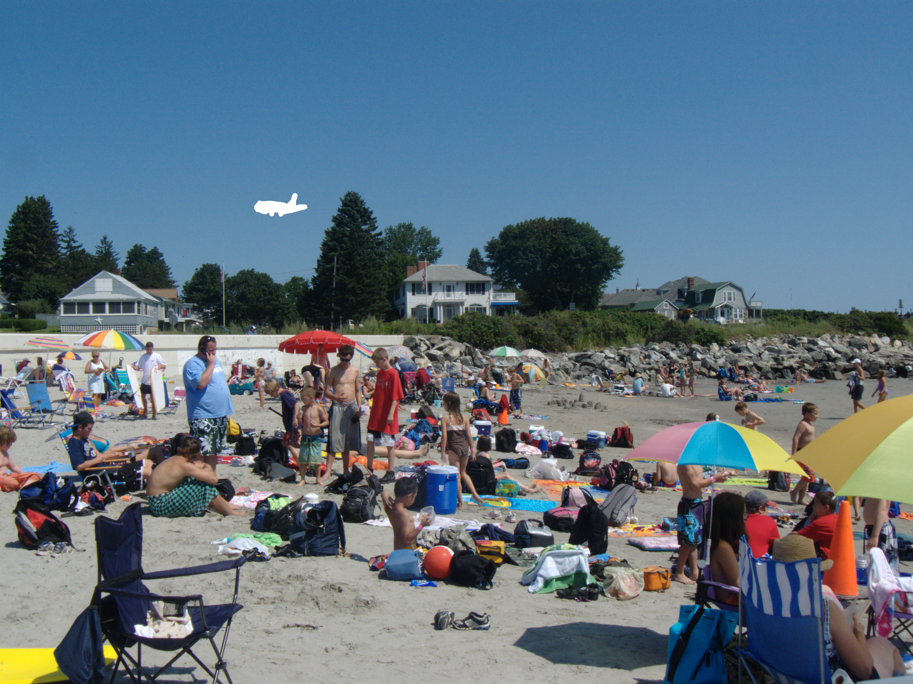 Beach scene with erased plane in the sky